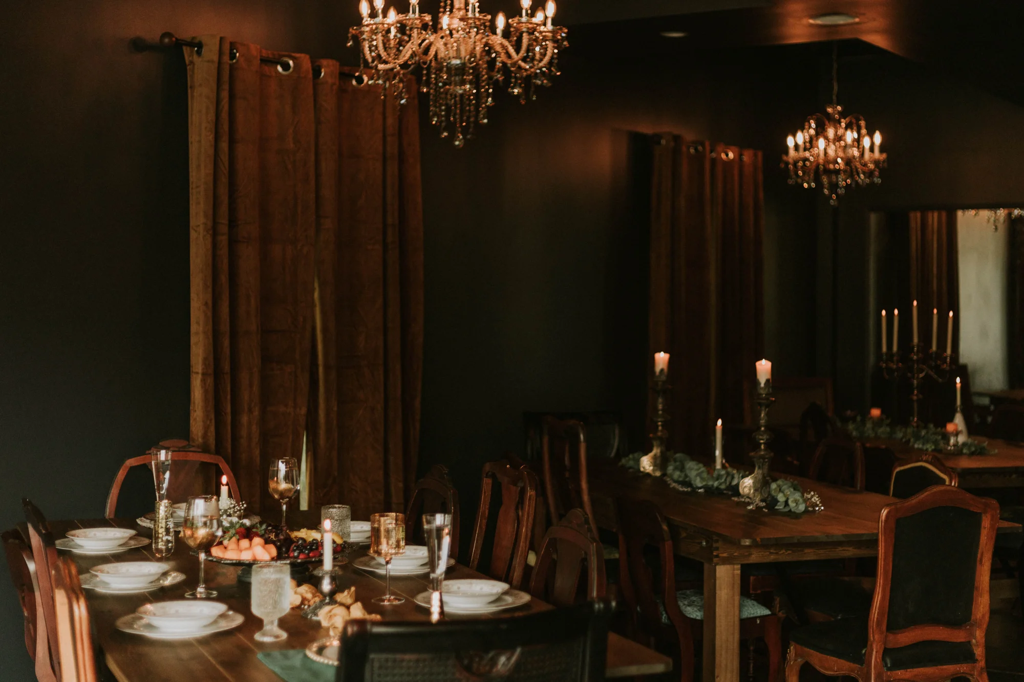 Warm chandeliers over a beautifully set table at The Parlour
